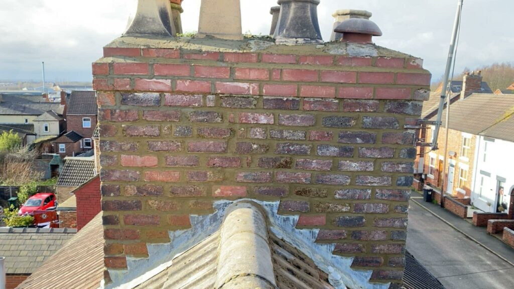 Completed chimney repair with restored masonry